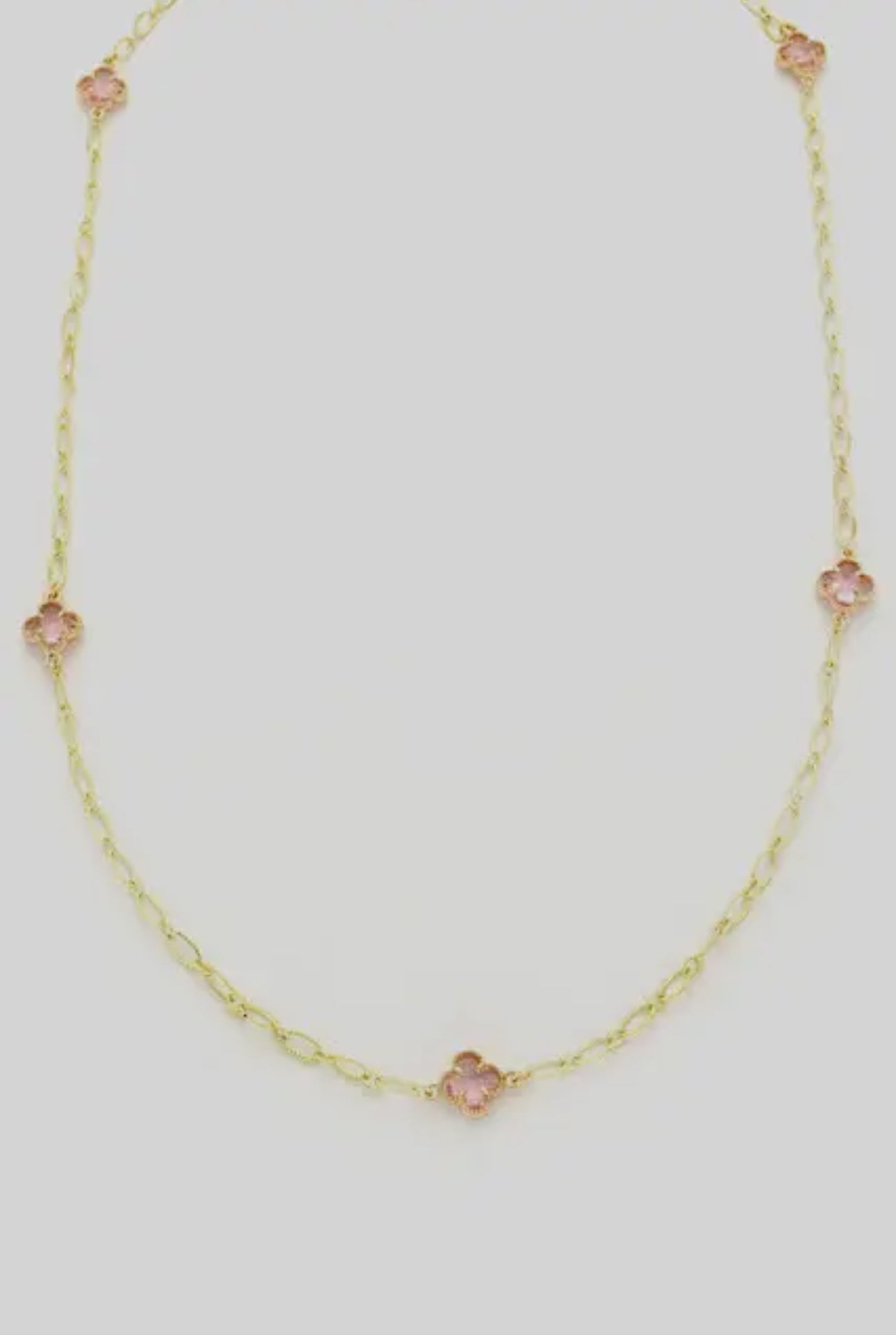 Delicate gold chain with three small pink clover-shaped stones. Available sizes: 16", 18", 20".