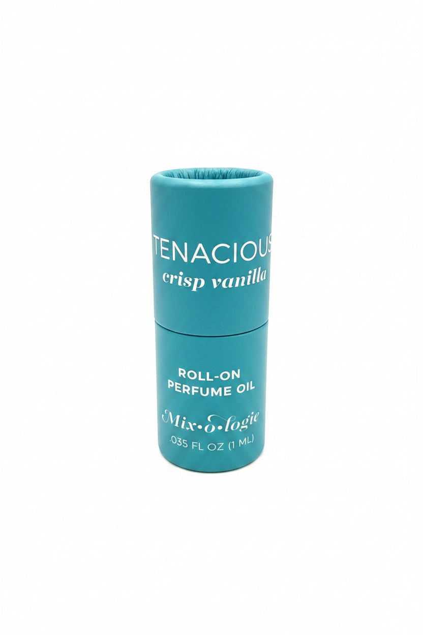 Teal cylindrical Keychain Mini Rollerball Perfume labeled “TENACIOUS crisp vanilla,” 0.35 FL OZ/11 mL, long-lasting scent.