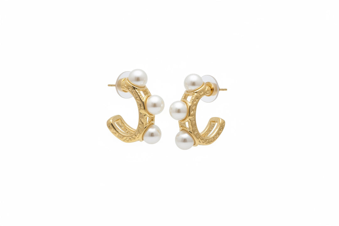 Gold hoop earrings with three white pearls each; water resistant. Available in small, medium, and large sizes.