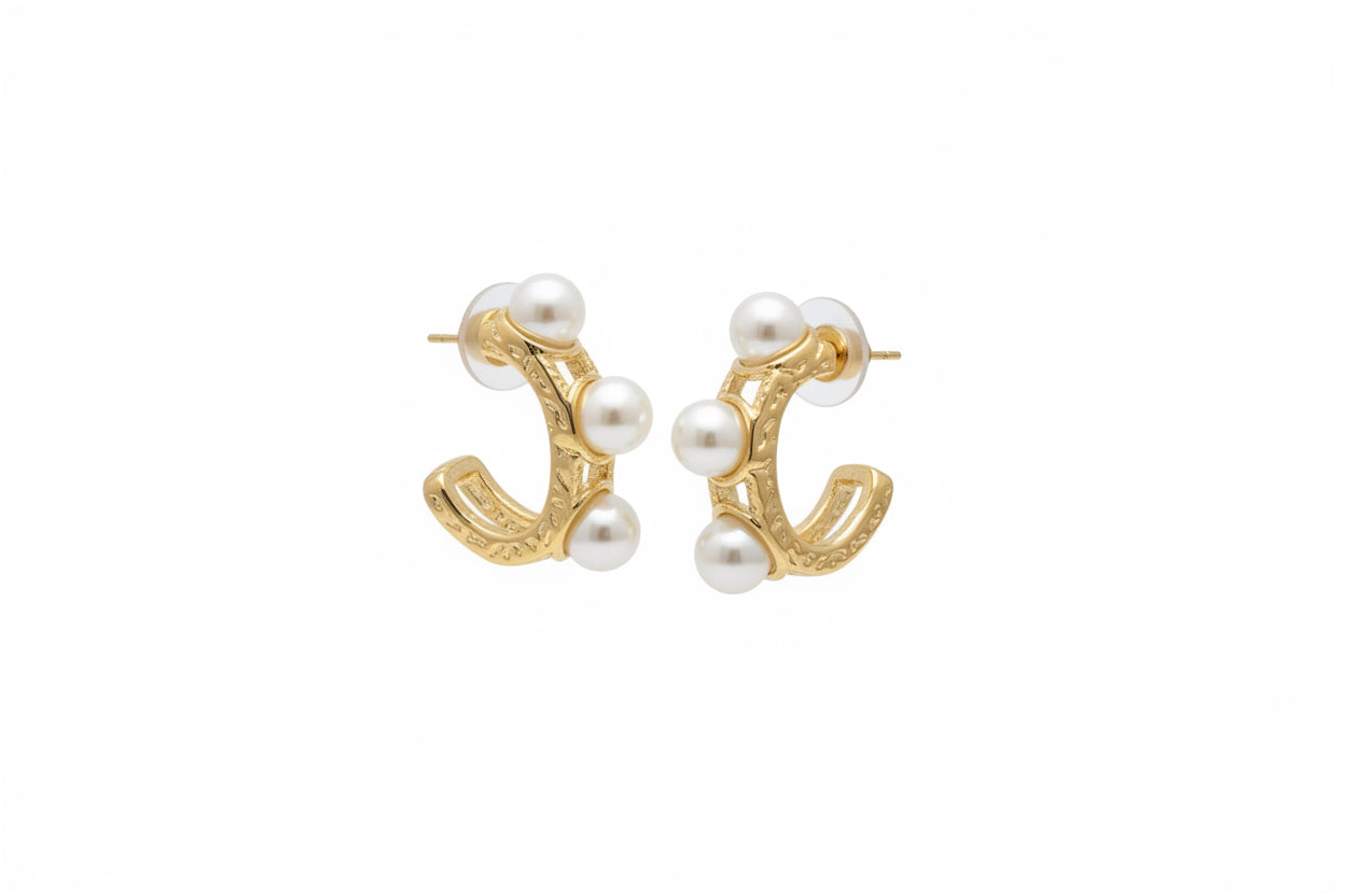 Gold hoop earrings with three white pearls each; water resistant. Available in small, medium, and large sizes.