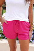 Solid Raspberry Everyday Shorts, available in sizes XS–XL, shown with side pockets.