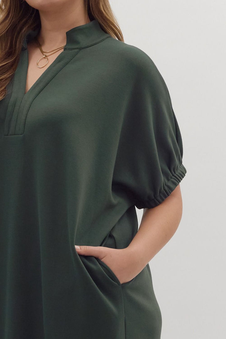 Dark green Collie midi dress with V-neck, band collar, short puff sleeves, and gathered cuffs.