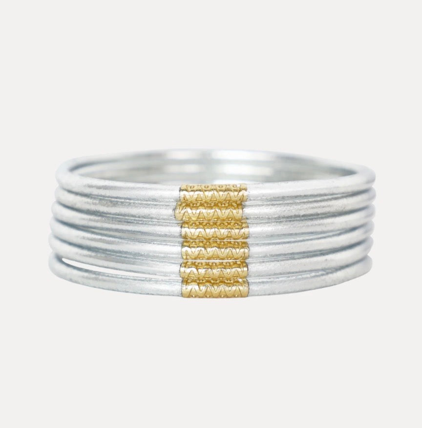 Silver ring with five slim stacked bands and a gold wire accent; available in large size.