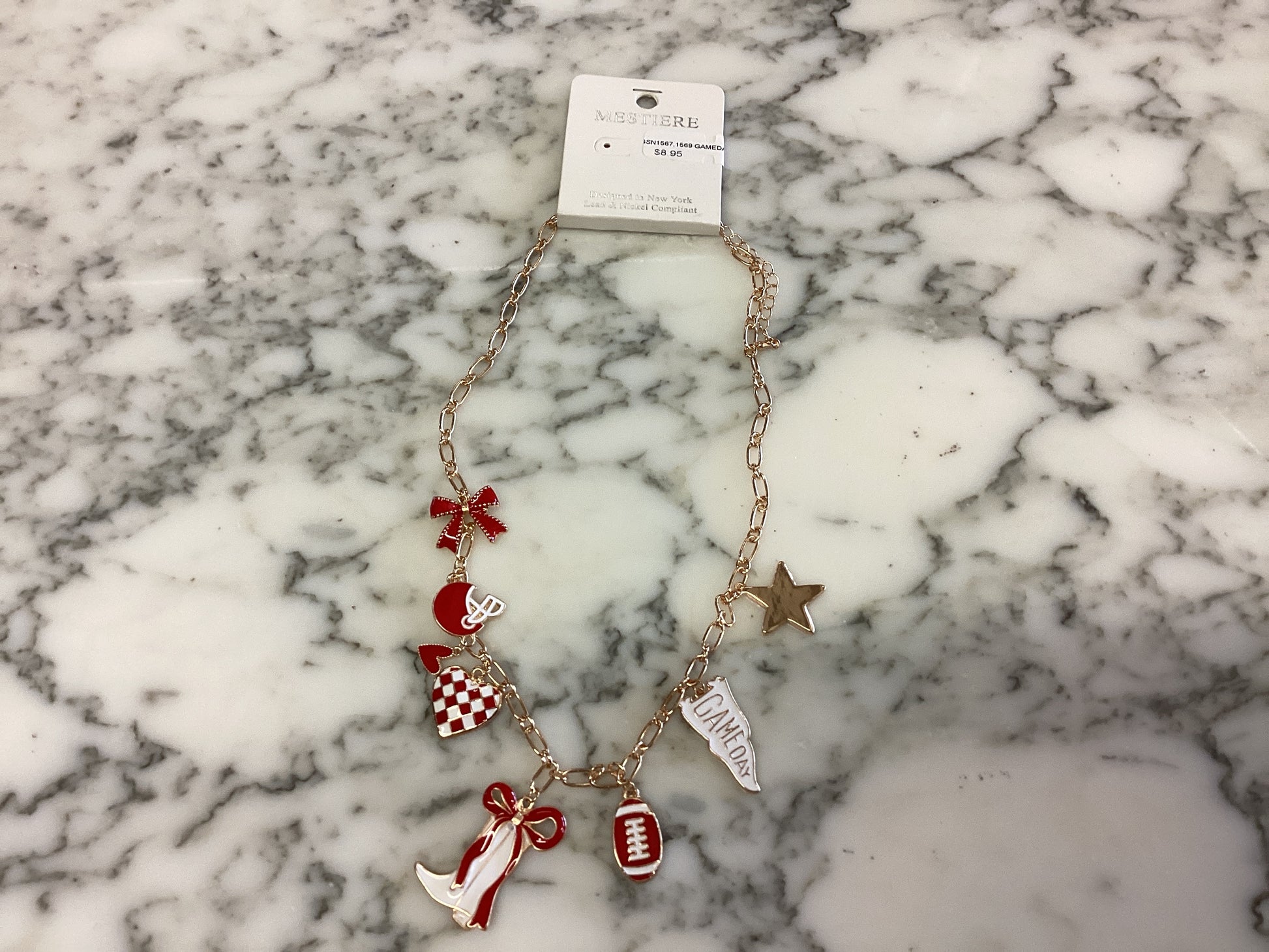 Game Day Necklace with gold chain and red, white, and gold football-themed charms: helmet, star, football, megaphone, pom-pom, and bow. Available in multiple sizes.