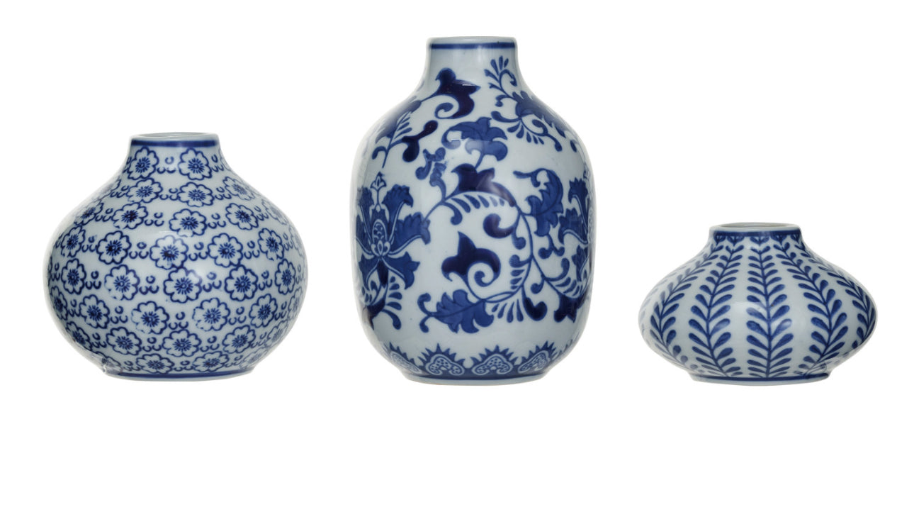 Hand-stamped stoneware vases featuring intricate blue floral and foliage patterns. Available sizes: short and round, taller and bulbous, small and squat.