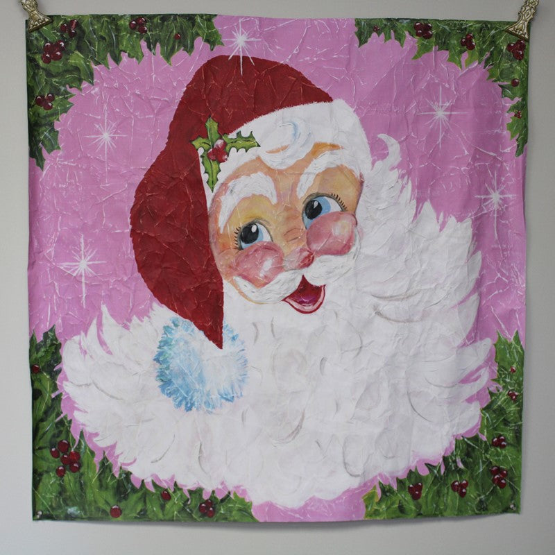 Paper Art Jolly Santa Face square wall hanging with a jolly Santa, white beard, red hat, and holly border. Available in square.