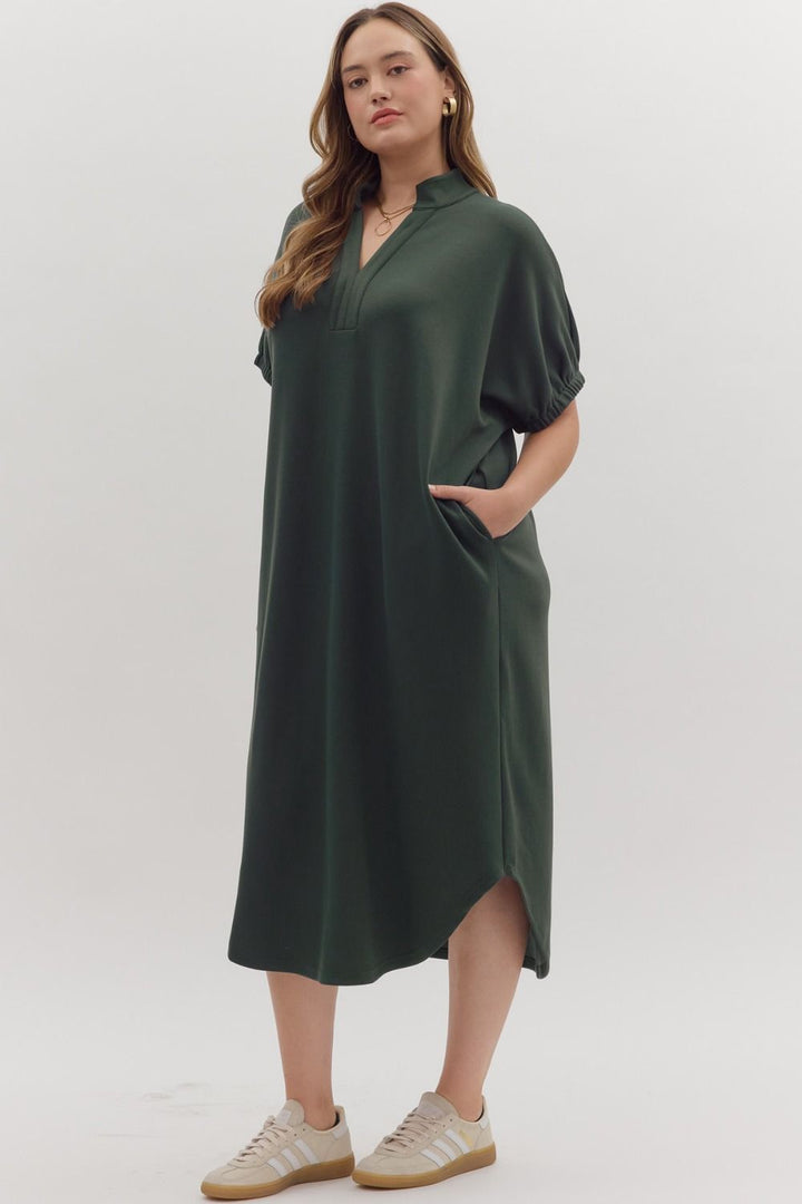 Dark green Collie Midi Dress with V-neck, band collar, short sleeves, and side pockets. Available in multiple sizes.