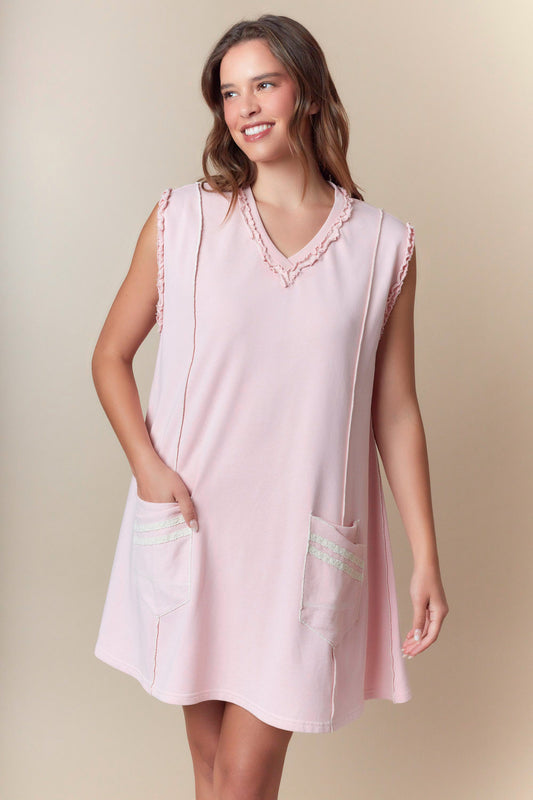 Sleeveless light pink A-line dress with ruffled V-neck, lace-trimmed pockets. Available in sizes XS-XL.