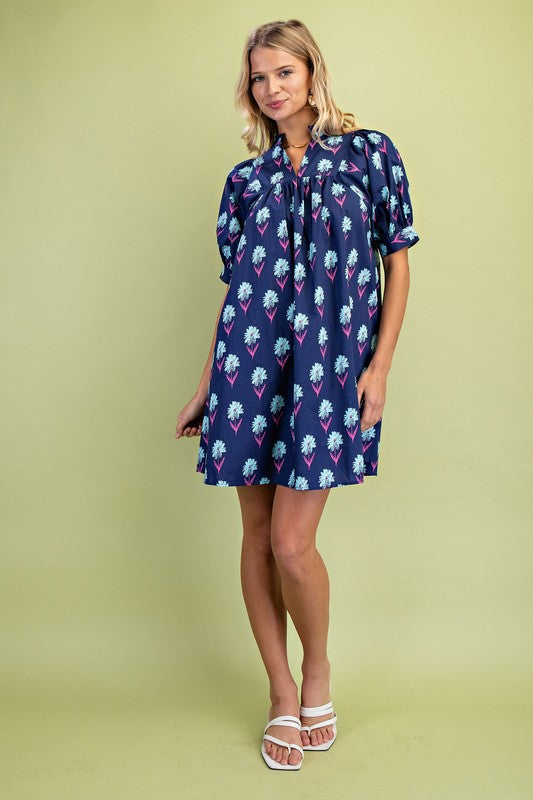 Midnight Floral Print Mini Dress: loose-fitting, short sleeves, purple and blue floral cotton. Sizes: XS-XL.