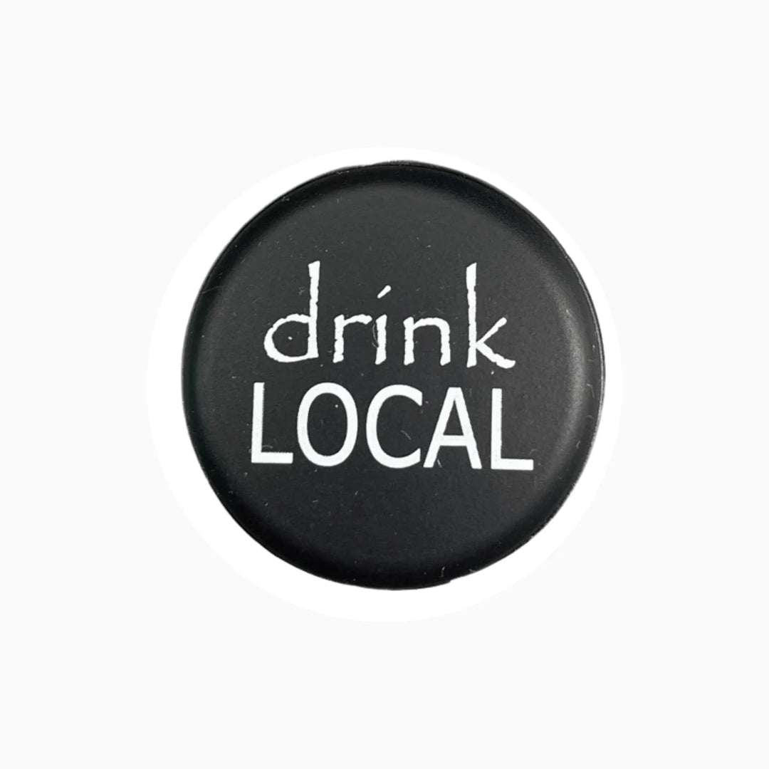 Round black wine stopper with "drink LOCAL" in white text. Available in multiple sizes.