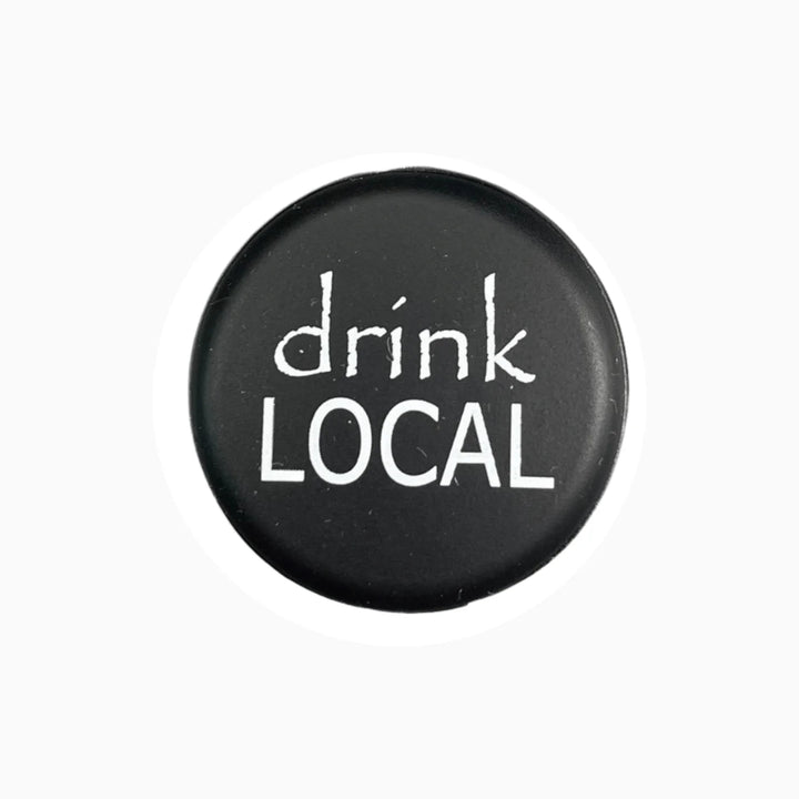 Round black wine stopper with "drink LOCAL" in white text. Available in multiple sizes.