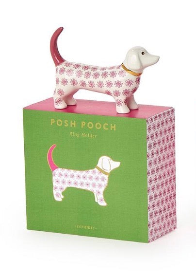 The Posh Pooch Dog Ceramic Ring Holder is a ceramic dog figurine with a pink floral pattern. Available in 3 assorted colors and sizes.