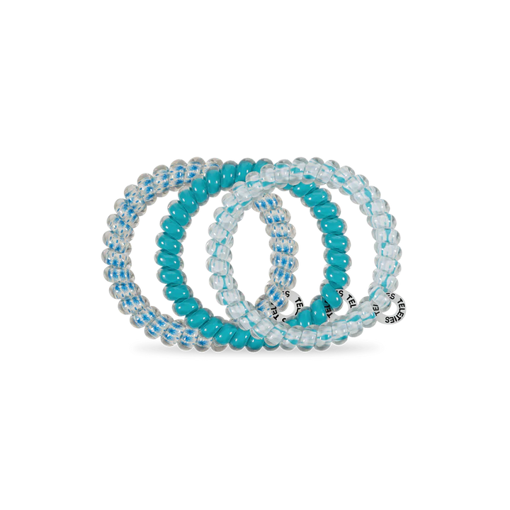 Three TELETIES Hair Ties: two clear with blue stripes, one solid turquoise, each with a small charm. Available in various sizes.