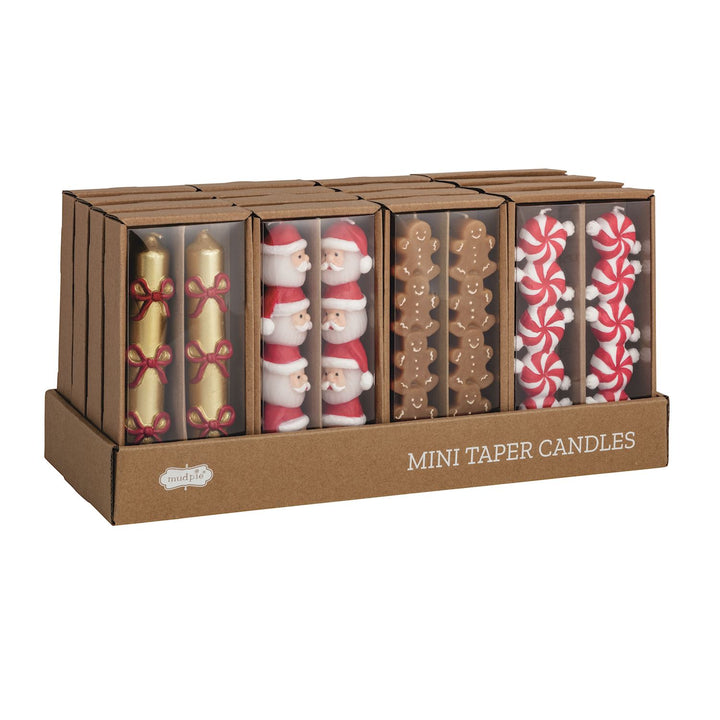 Christmas Mini Taper Candles in a display box featuring hand-painted Santa, gingerbread, and peppermint designs with red and gold bows.