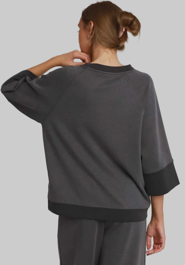 Charcoal colorblock raglan top with ultra-soft fabric, raglan sleeves, and contrasting cuffs and hem.