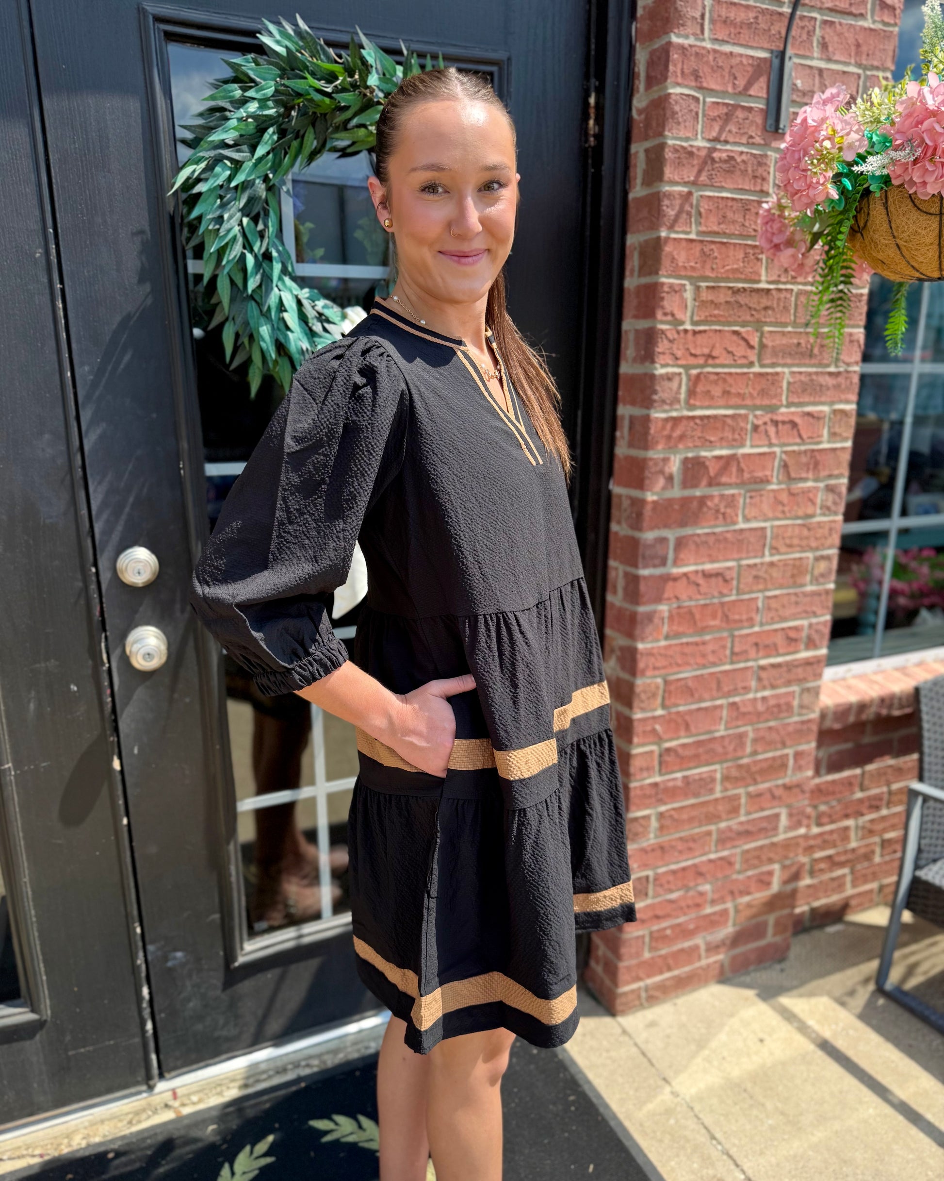 Cooper Dress in Black + Tan with tan stripes and tiered skirt; available in sizes XS–XL.