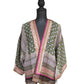 The Moorish Pattern Short Kimono: Stylish kimono crafted in Sheffield, England with green, pink, cream, and black colors featuring intricate floral and geometric designs. Wide three-quarter-length sleeves and open front. Available sizes: S/M, L/XL.