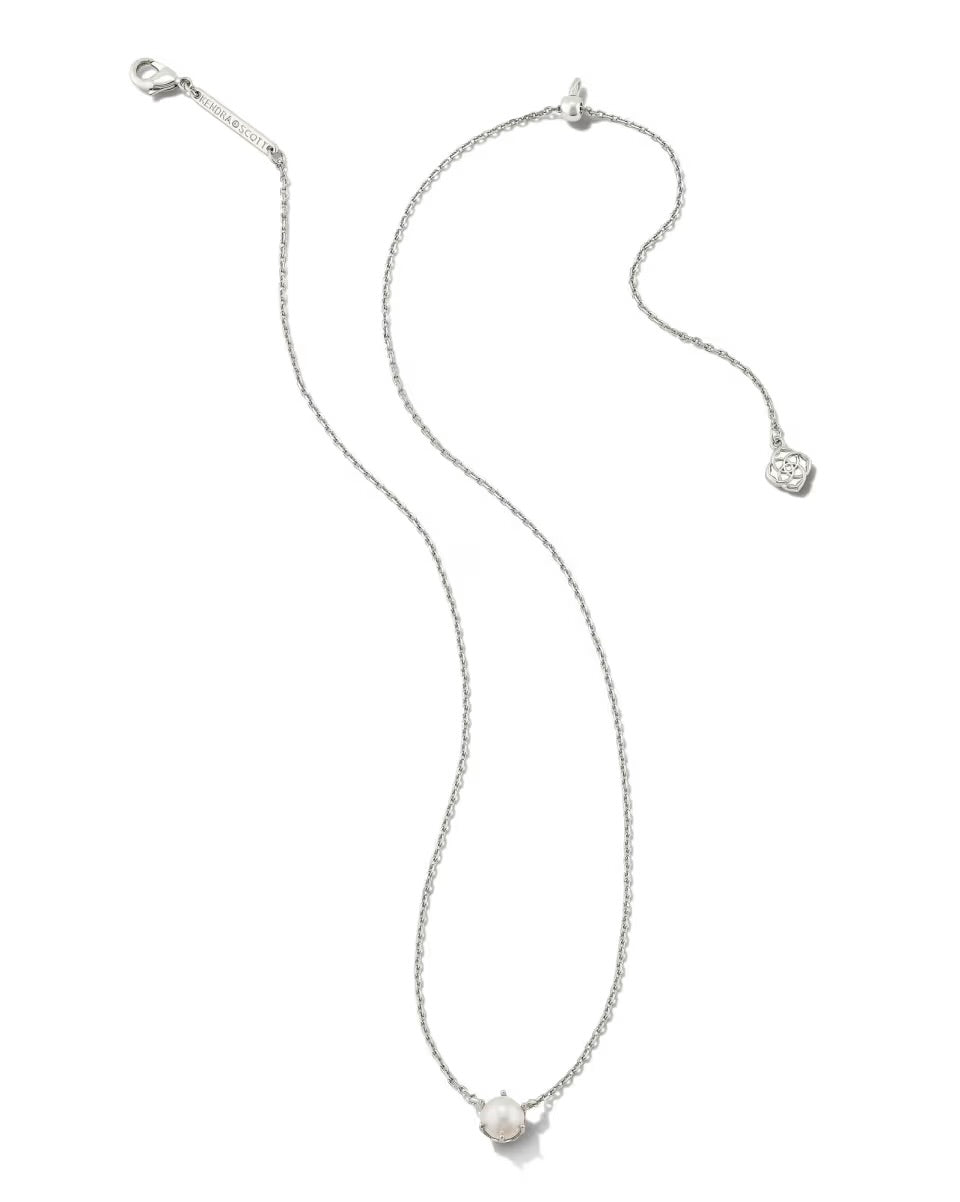 The Ashton Pearl Necklace by Kendra Scott: delicate silver chain, single round pearl pendant, small tag near clasp. Sizes: 16", 18".