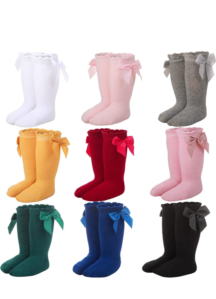Set of 9 baby knee-high socks with side bows in assorted colors, newborn size.