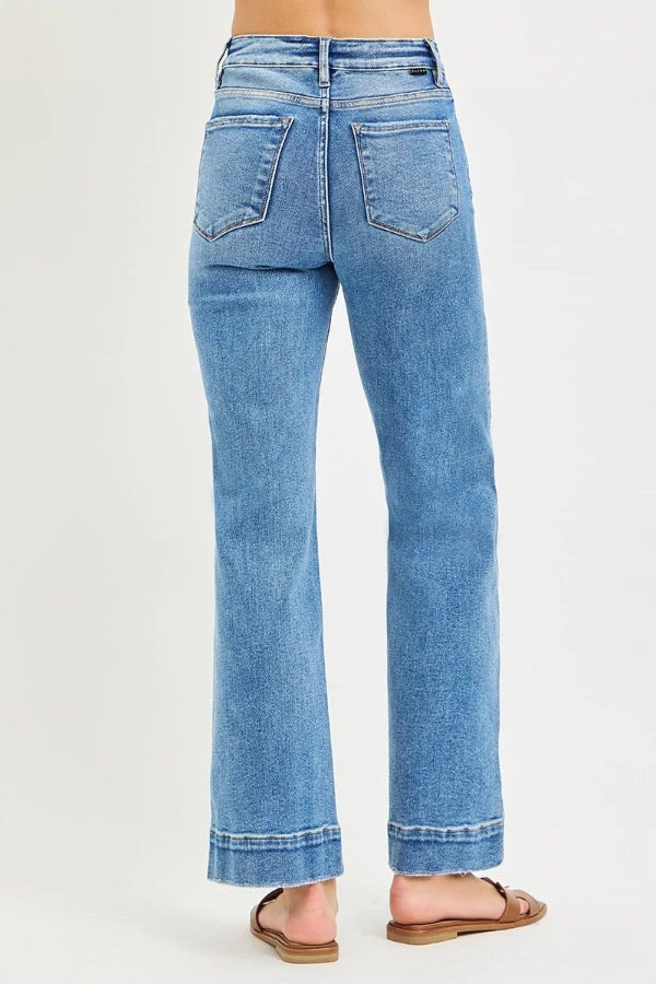 Risen Tummy Control High Rise Straight Jeans in medium-wash blue with a straight-leg fit and wide hem. Available in multiple sizes.