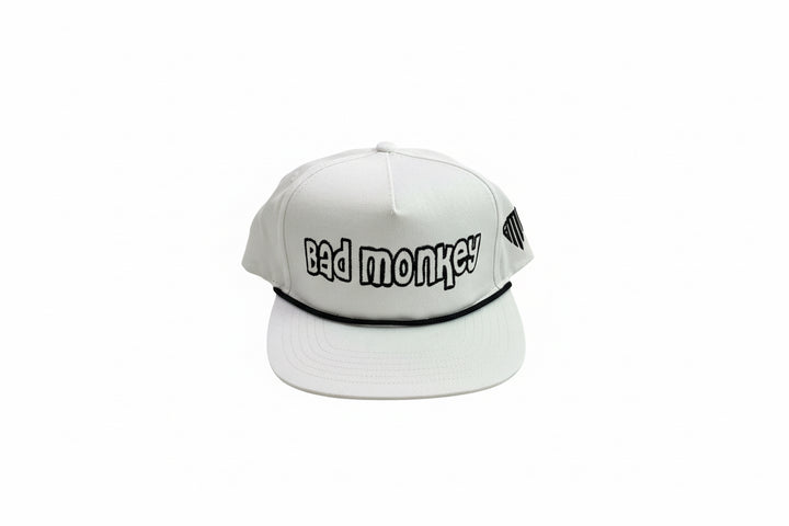 White adjustable cap with "bad monkey" in bold black letters on the front. Available sizes: S, M, L, XL.