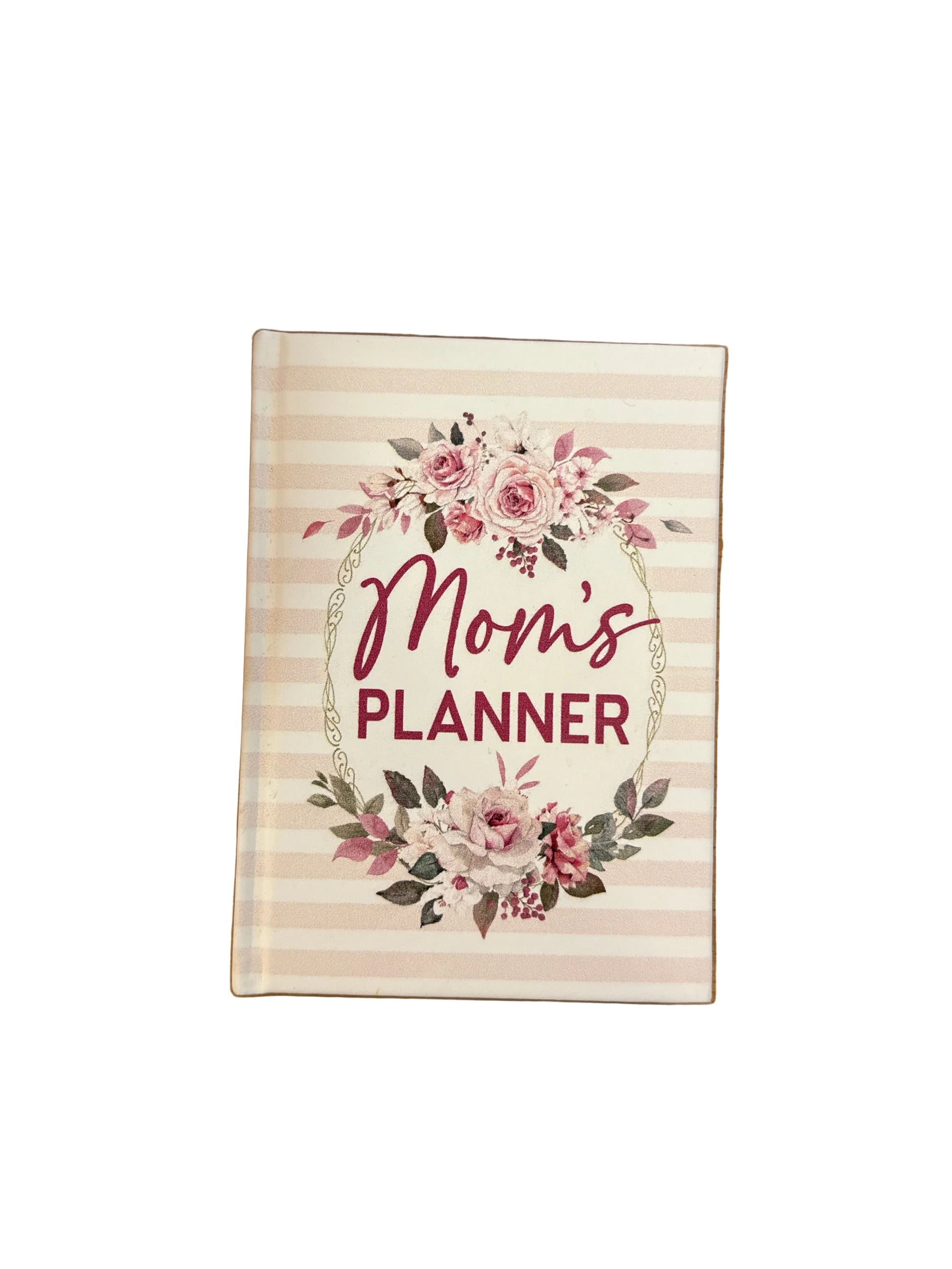 The Mom’s Planner Notebook has light pink stripes, floral designs, and “Mom’s Planner” in bold, dark pink letters. Available sizes: small, medium, and large.