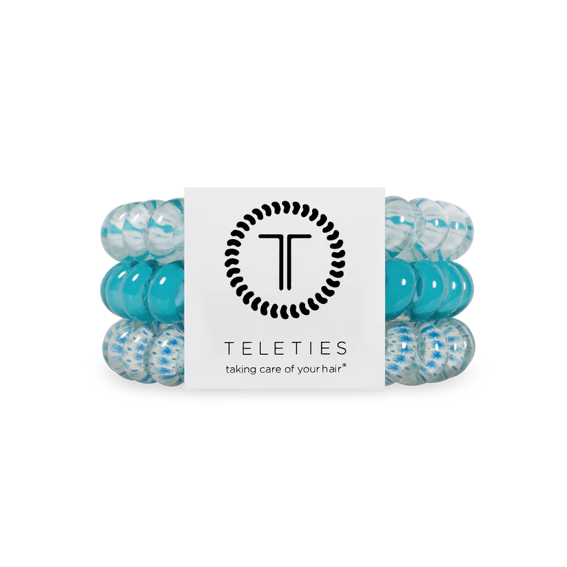 Three spiral TELETIES Hair Ties in blue and clear, labeled; available in small and large sizes.