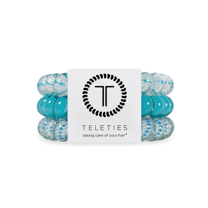 Three spiral TELETIES Hair Ties in blue and clear, labeled; available in small and large sizes.