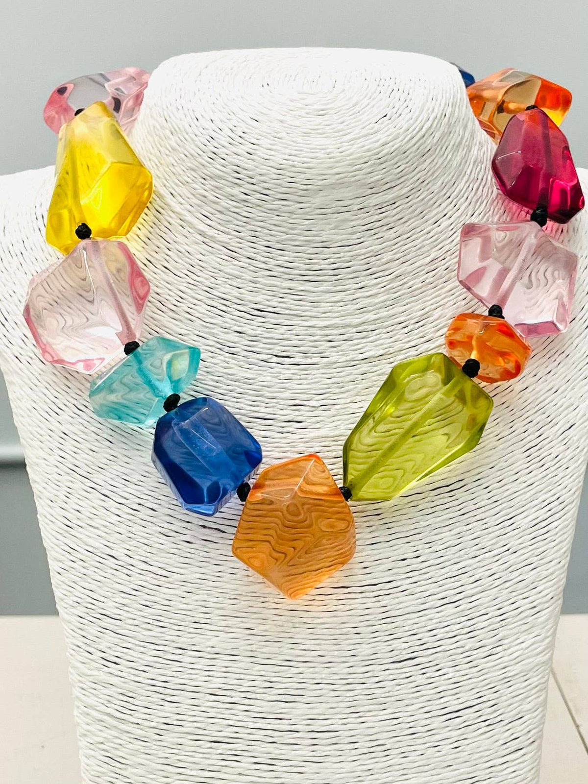 The CHIC - Clear Stone Necklace (multi) NK890 features large, faceted acrylic beads in vibrant pink, yellow, blue, orange, green, and red, separated by small black spacers. Available in one size.