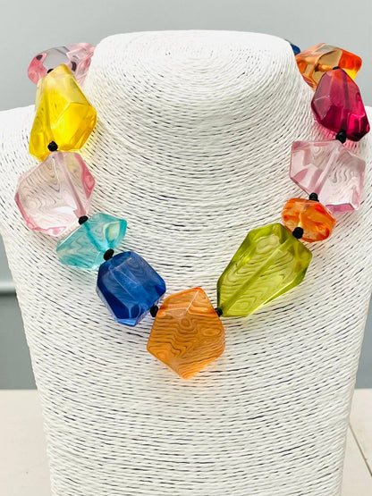 The CHIC - Clear Stone Necklace (multi) NK890 features large, faceted acrylic beads in vibrant pink, yellow, blue, orange, green, and red, separated by small black spacers. Available in one size.