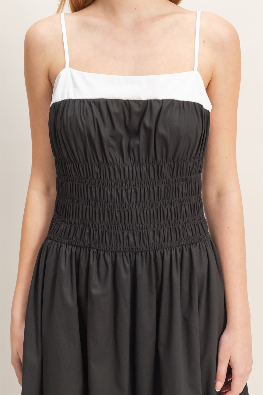 Smocked Strapped Midi Dress with thin straps, white top, black smocked bodice, gathered skirt; 2 colors; sizes XS-XL.