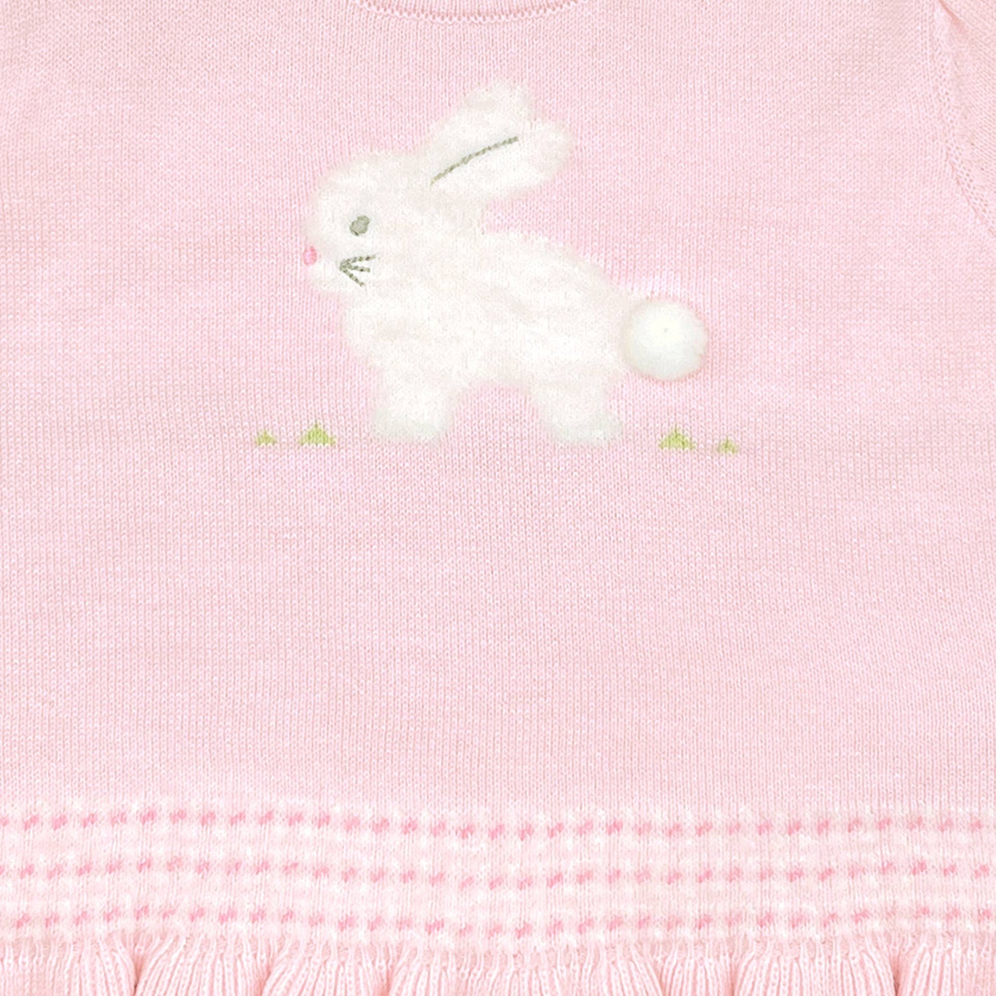 A close-up image of the Fuzzy Bunny Lightweight Knit Sweater in Pink featuring a white embroidered bunny with a fluffy tail and green accents around it, crafted from 100% cotton yarns.