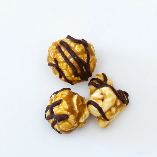 Valentine's Day Dark Chocolate Raspberry Poppy Popcorn: Gourmet popcorn drizzled with dark chocolate and raspberry. Sizes available: three-piece set.