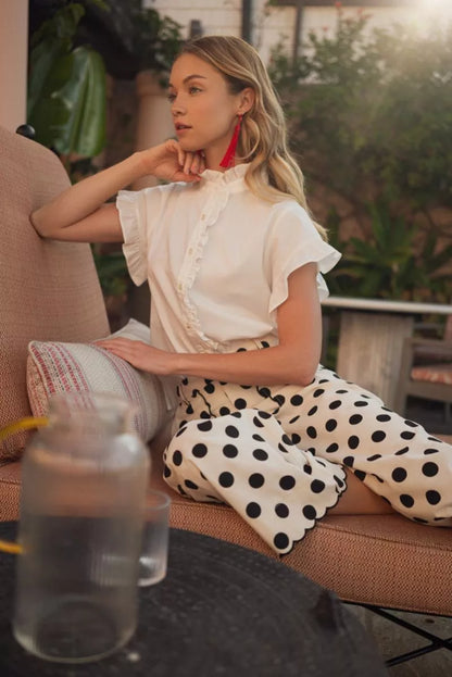 White Drop Shoulder Ruffle Top, available in sizes XS-XL. Features ruffled drop shoulders and a relaxed fit.