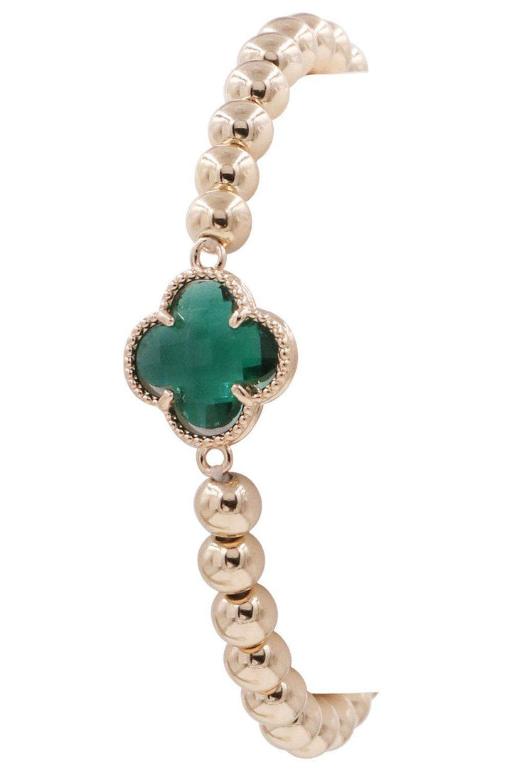Gold beaded bracelet with a four-leaf clover crystal charm in gold frame. Available in S, M, and L sizes.