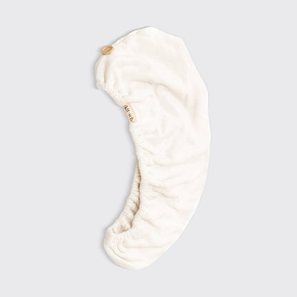 Cream-colored microfiber hair towel wrap with button closure; eco-friendly. Available in S/M and L/XL. Quick-drying care.