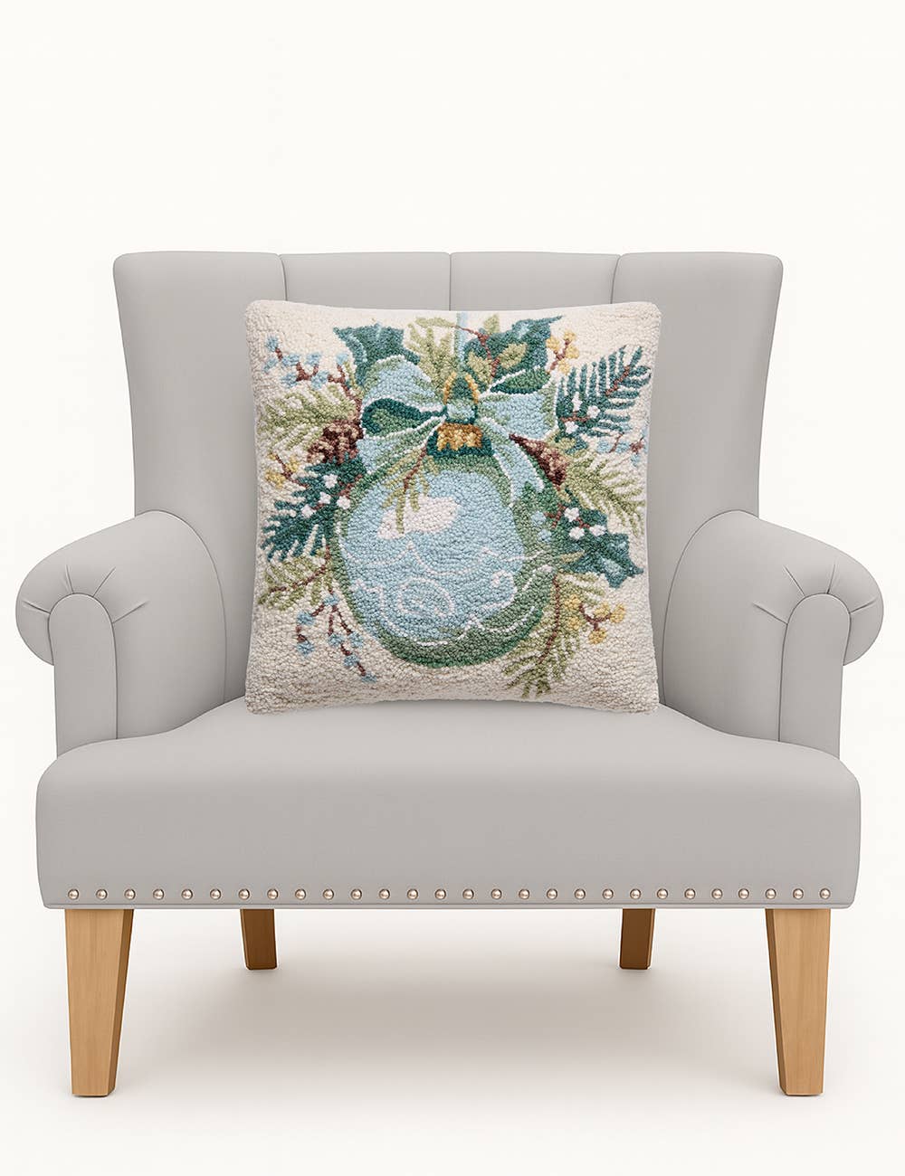 Ornament Square Hook Pillow: a wool Christmas throw pillow with an embroidered holiday wreath, greenery, bow, and pinecones. Available in 18″x18″.
