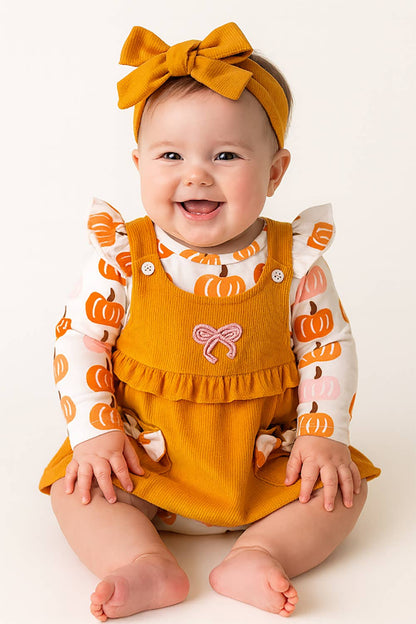 Pumpkin Harvest 3-Piece Baby Dress Outfit includes a soft mustard yellow dress, matching bow headband, and white shirt with orange pumpkin prints. Available in sizes 0-18 months.