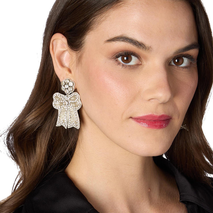 Silver crystal-embellished bow dangle earrings.