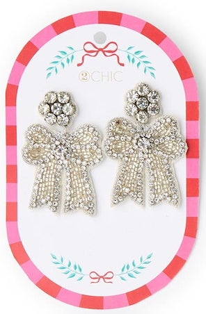 Holiday Icon Earrings with crystal-encrusted bow dangles and flower-shaped studs.