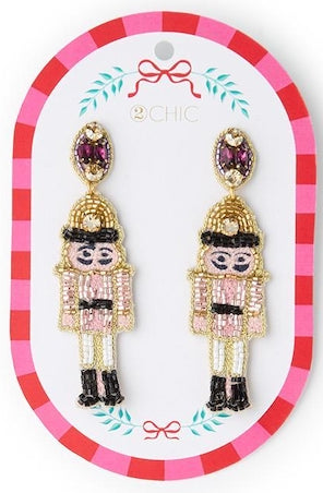 Beaded nutcracker earrings with purple crystal studs.