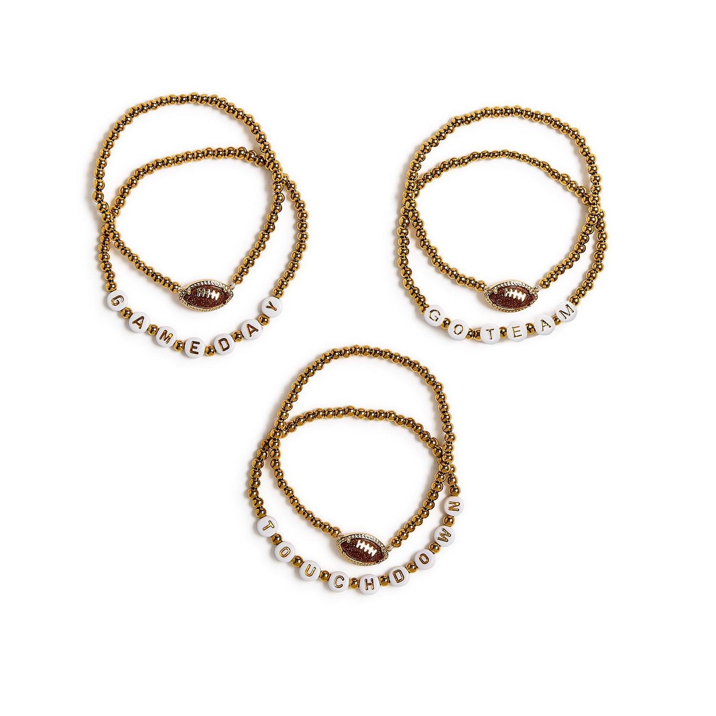 The Game Day Stretch Bracelet Set includes three gold beaded stretch bracelets with small football charms and letter beads spelling “GAME DAY,” “GO TEAM,” and “TOUCHDOWN.” Available in multiple sizes.