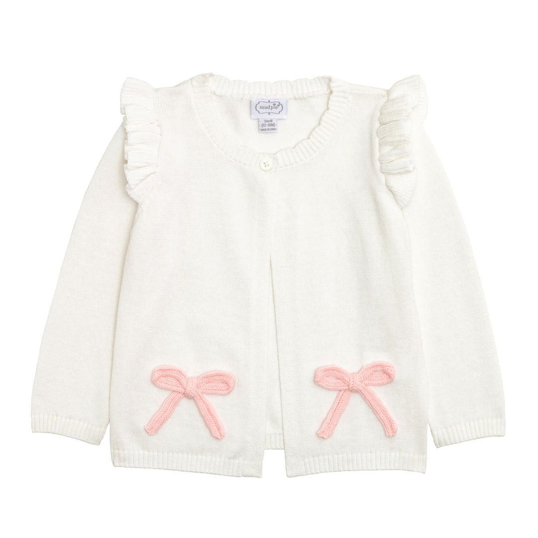 Pink cotton baby cardigan with ruffled shoulders, crochet bows on pockets, long sleeves, single neck button. Sizes: NB-24M.