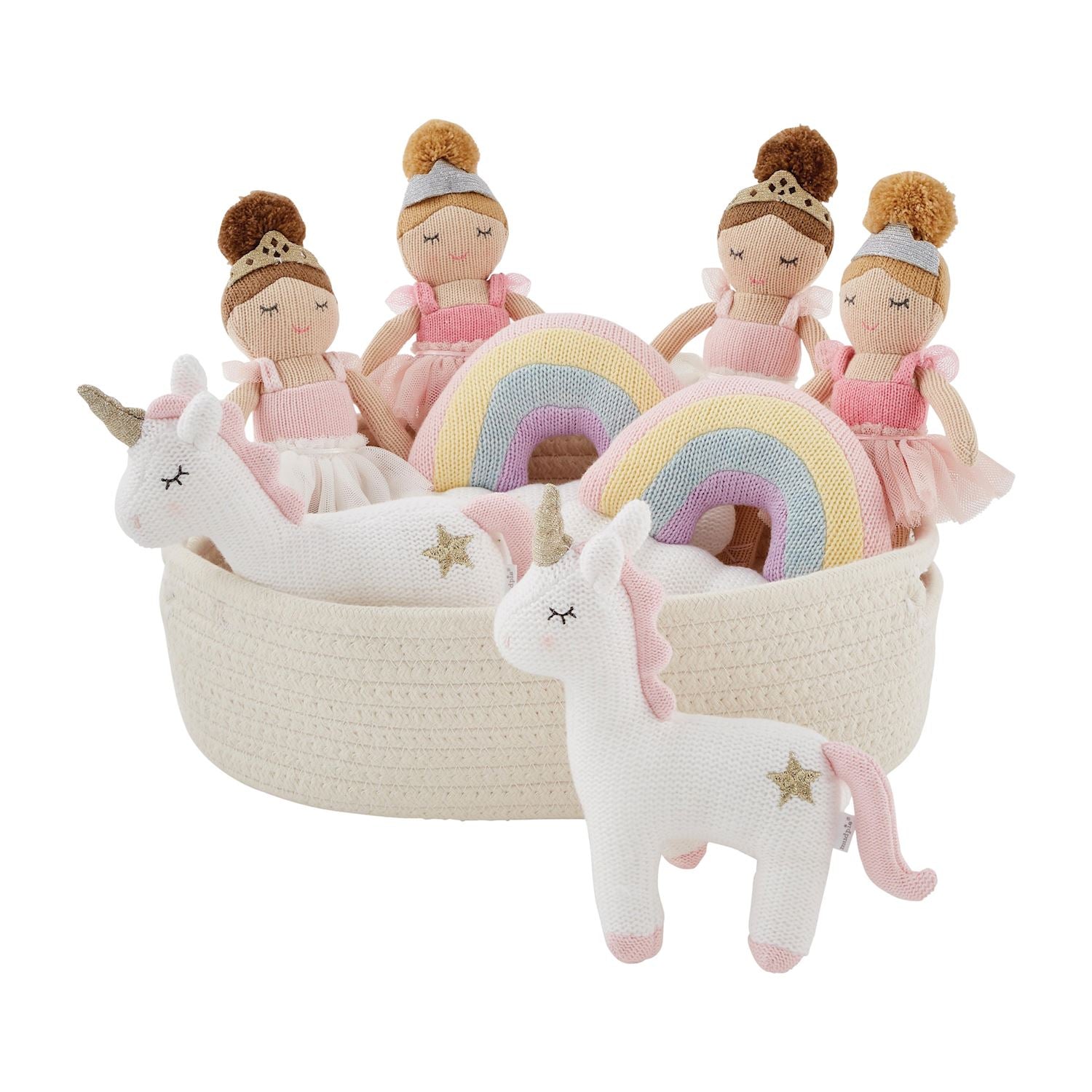 A collection of children's toys including three Unicorn Plush Toys with Rainbow Manes, two plush unicorns, and a rainbow, all arranged in a beige woven basket.