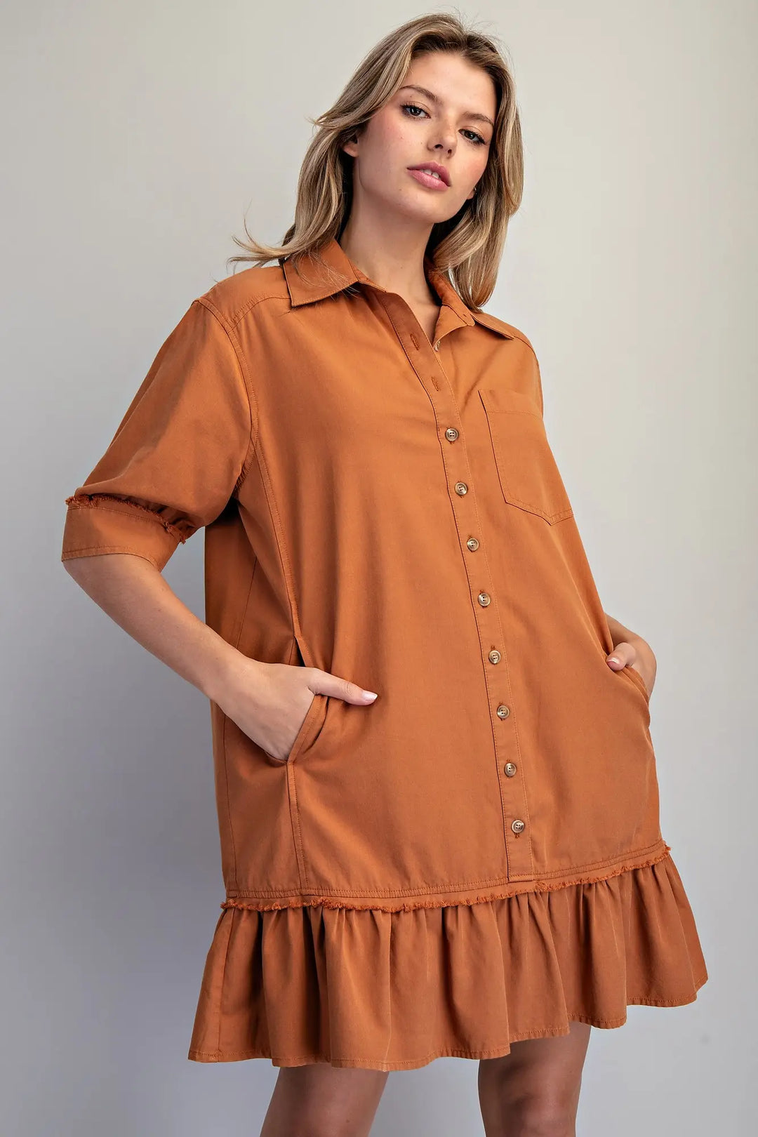Clay Button Down Mini Dress: loose fit, short sleeves, collar, chest pocket, side pockets, ruffled hem. Sizes XS-XL.