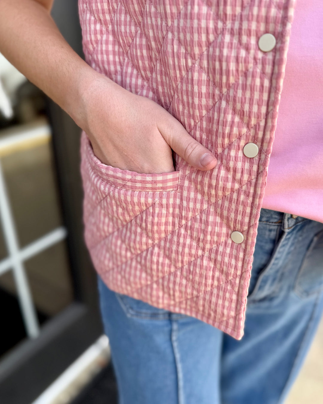 Blush Gingham Puffer Vest with metal snaps, available in sizes XS-XL.