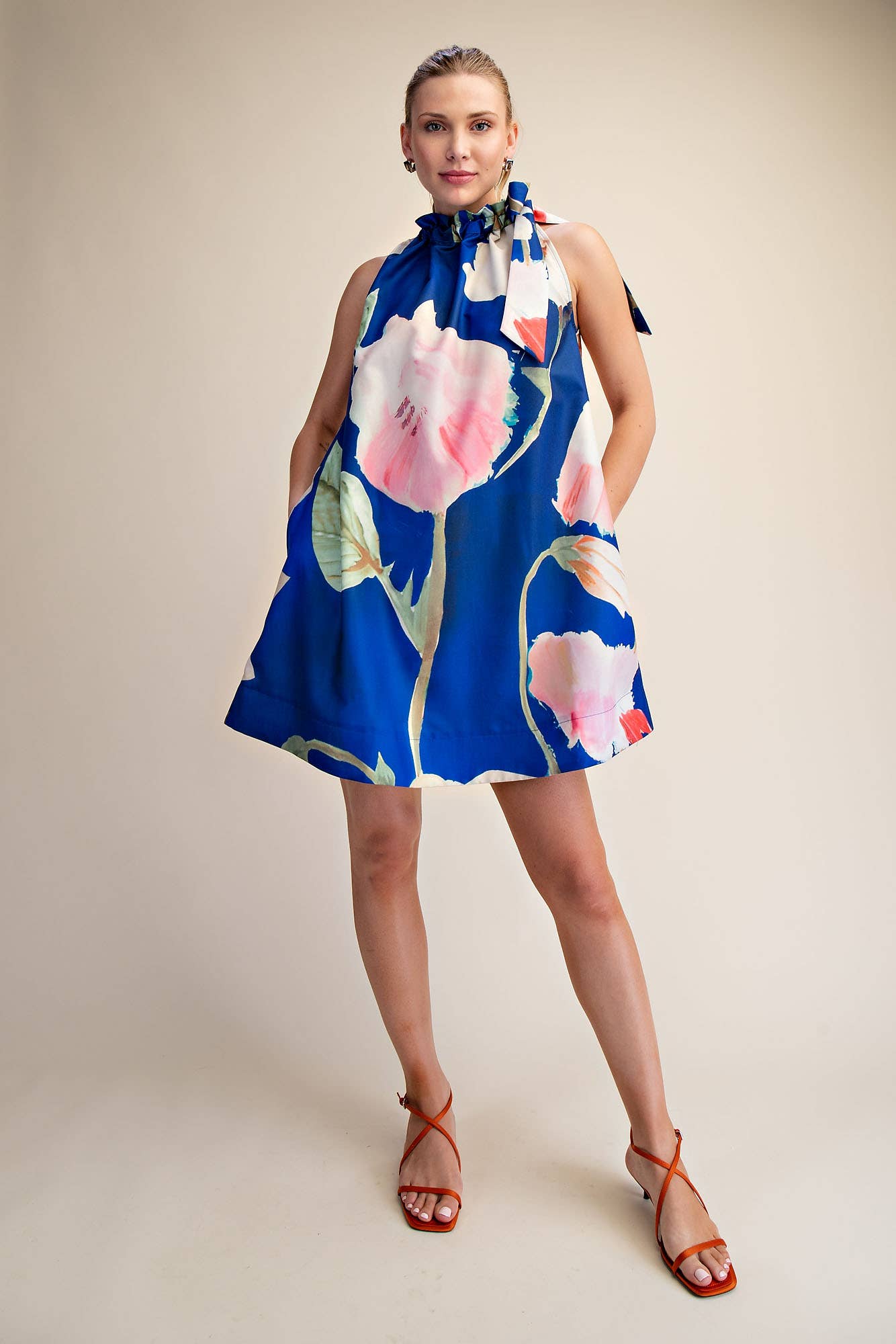 Mini Dress Ruffle Neck Tie Sleeveless Floral Print in Royal, available in sizes XS-XL.
