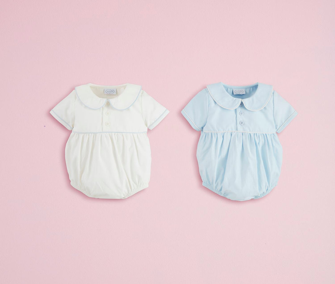 Two collared poplin baby bubbles in white and light blue with Peter Pan collars, short sleeves. Sizes: NB-24M.