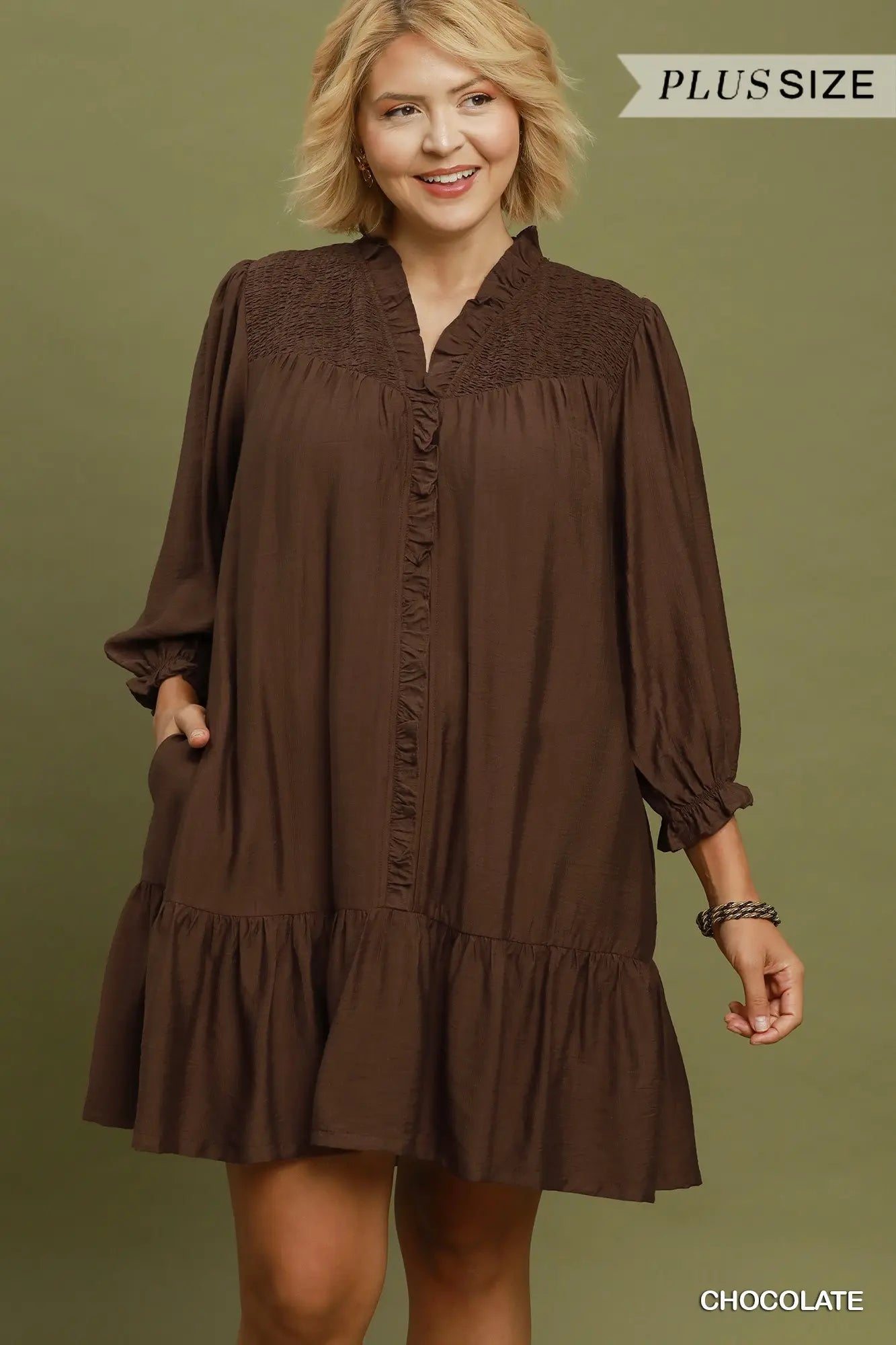 Brown, long-sleeved, knee-length smocked ruffle tiered mini dress with a flowy silhouette. Available in plus sizes.