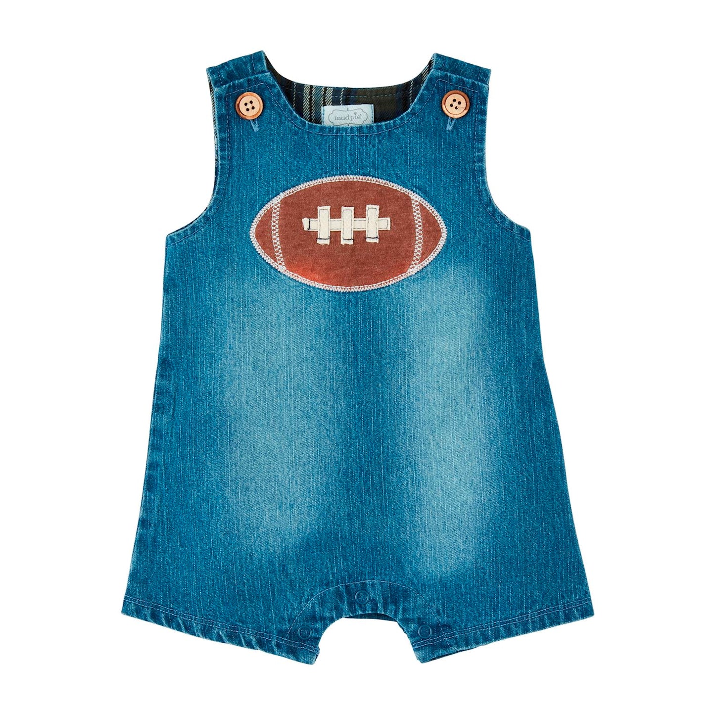 Denim Football Jon Jon for infants. Lined with coconut wood button shoulders and a chest applique of an American football with white stitching. 
Sizes: 3M, 6M, 9M, 12M, 18M, 24M.